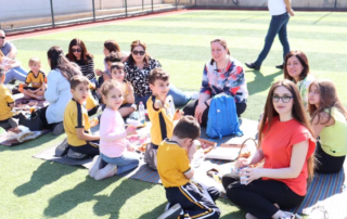 PYP1 students enjoying a picnic with their parents and teachers